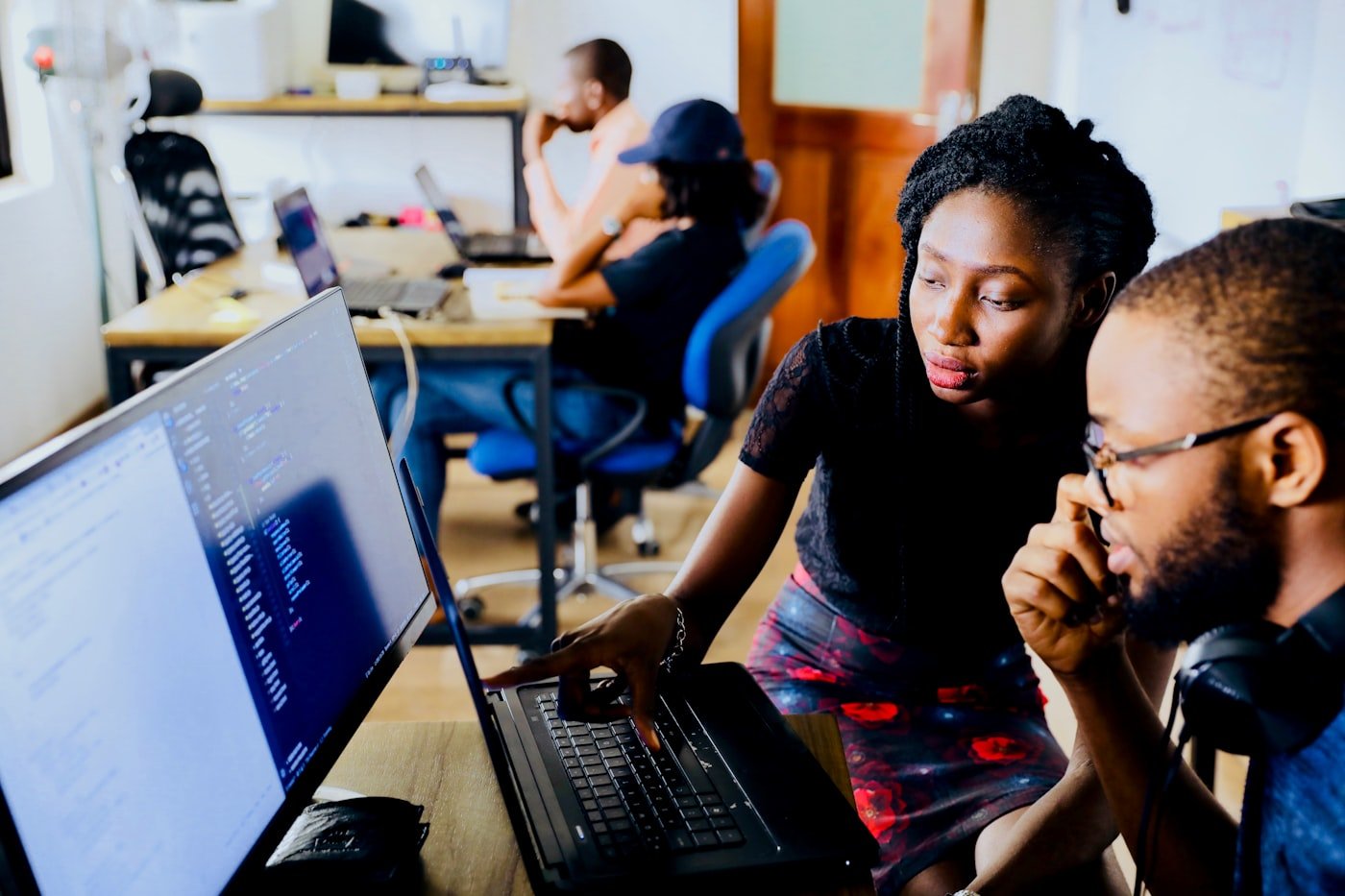 African American professionals collaborating on a project in the office