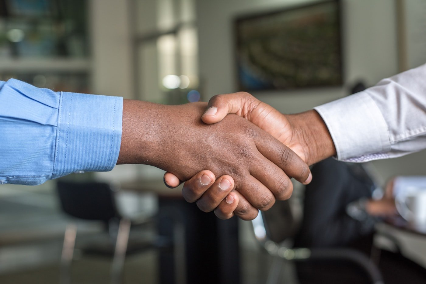 African American professionals sealing a partnership with a handshake